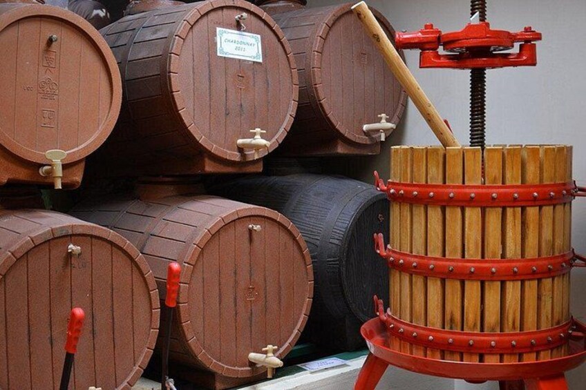 Wooden wine barrels stacked in a warehouse. 4