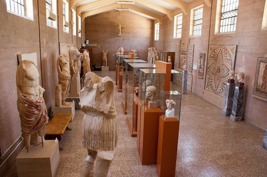 A museum interior with ancient sculptures and artifacts on display. 3