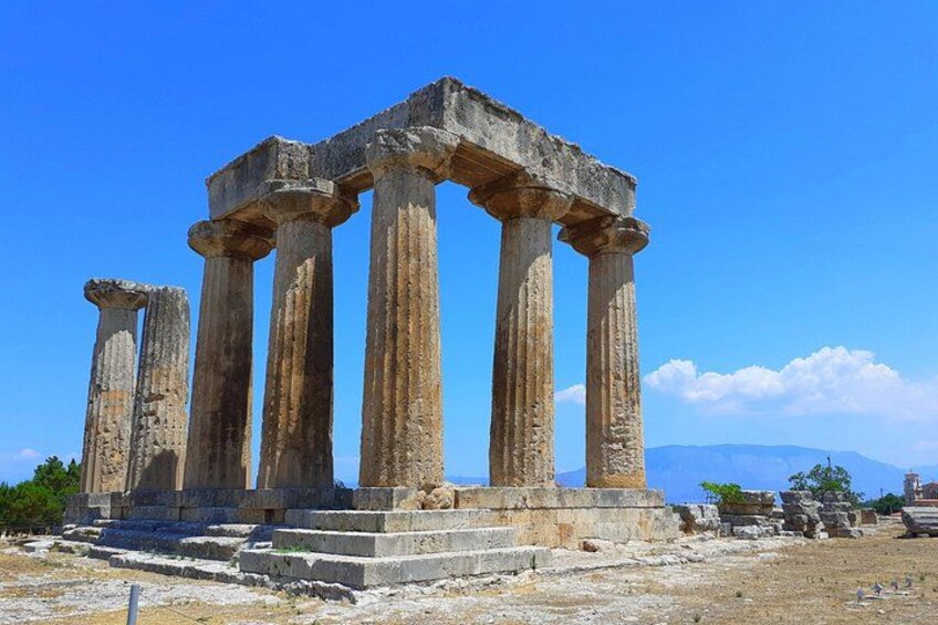 Ancient Greek columns with a clear blue sky in the background. 1
