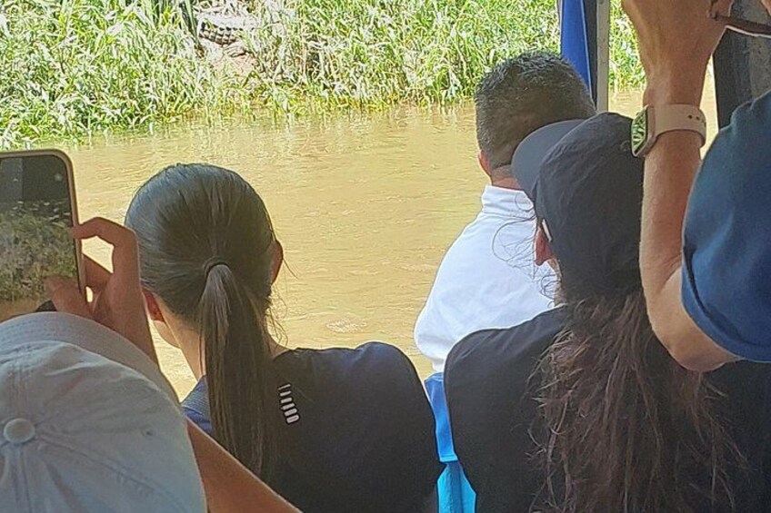 People seated on a boat, looking at a body of water. 4