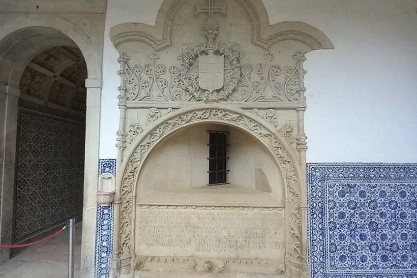 An ornate doorway with intricate carvings and a small window. 4