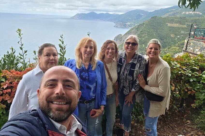 A group of people standing on a hill overlooking a coastal landscape. 2