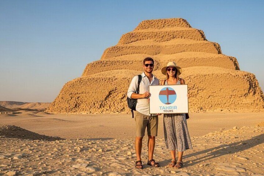 A pyramid in the background with a sign reading "TAHRIR TOURS" in the foreground. 1