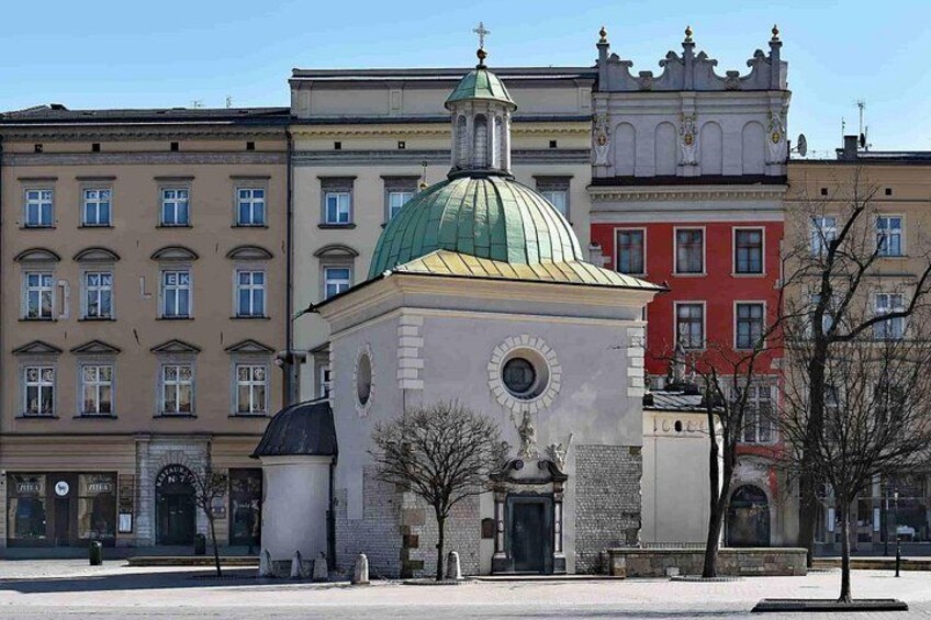 A church with a green dome, a clock, and a bell tower. 2