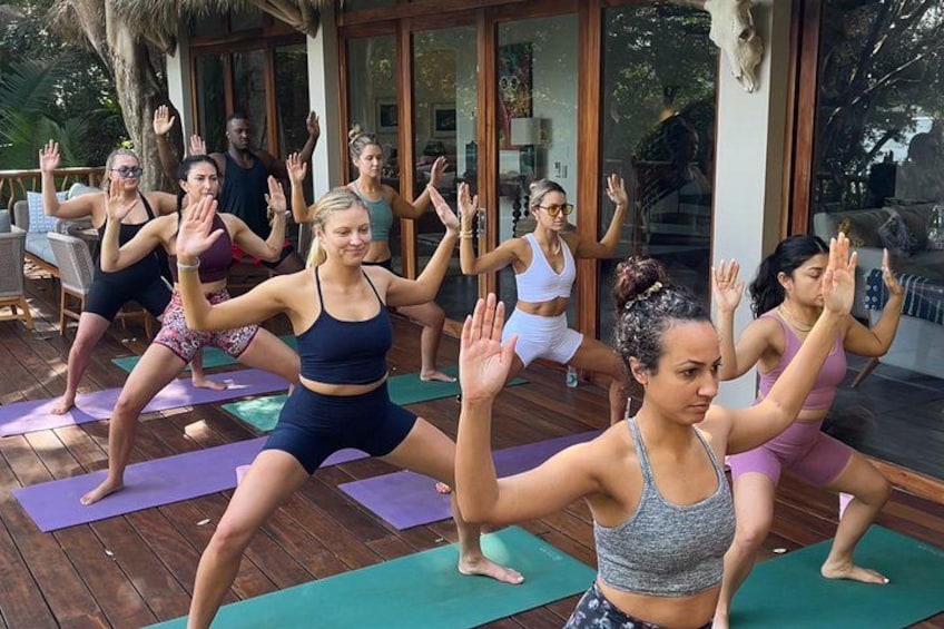 A group of people performing a yoga exercise on outdoor mats. 1