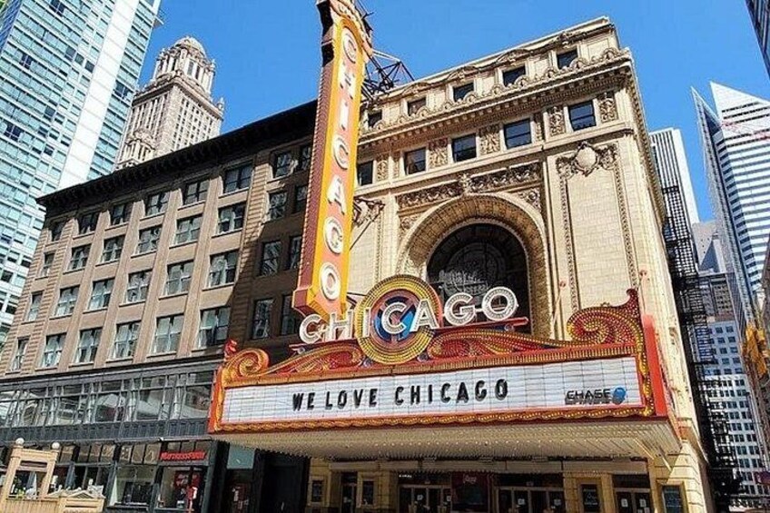 A theater with ornate architecture and the sign 'Chicago' prominently displayed. 2