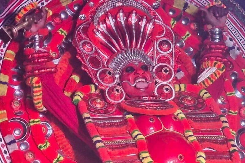 A traditional red and silver headdress with intricate patterns and designs. 4
