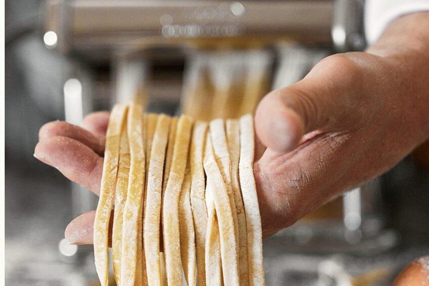 A person holding several thin, flat, golden-brown objects. 3
