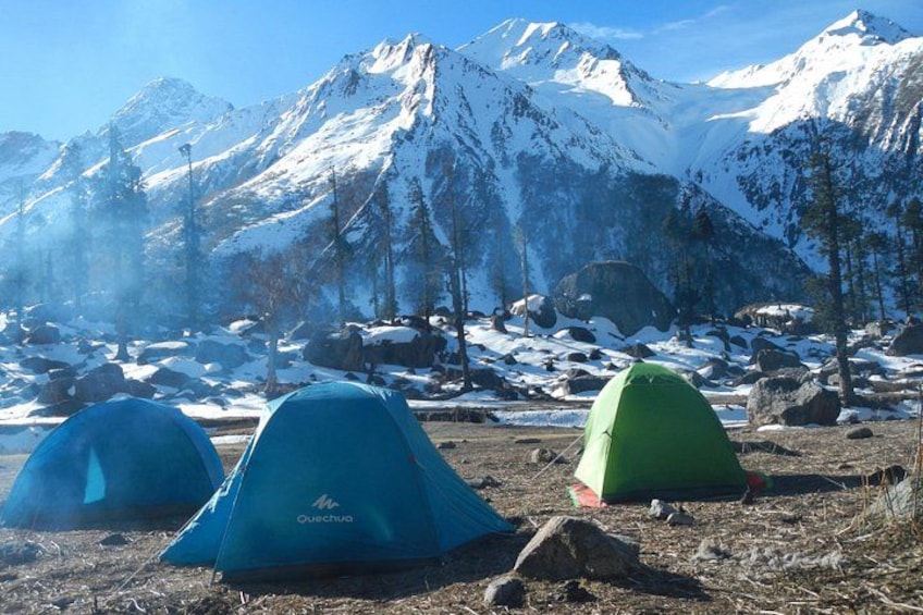 Two tents in a snowy mountainous area with clear skies. 2
