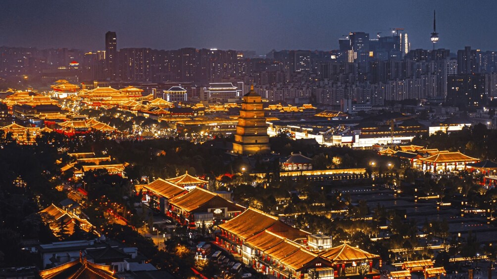 A cityscape at night with traditional architecture and a prominent pagoda. 5