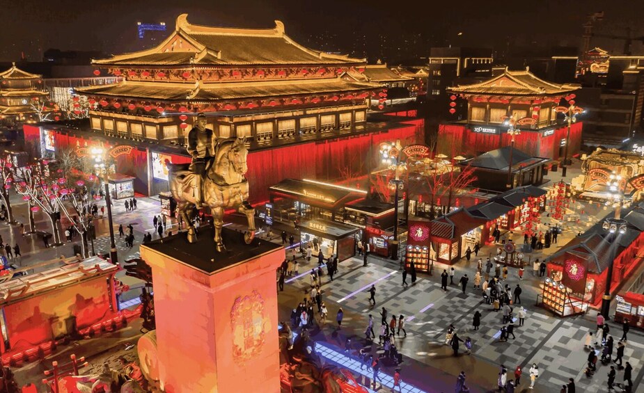A traditional Chinese architectural complex with ornate roofs and lanterns, surrounded by a bustling square with people and shops. 4