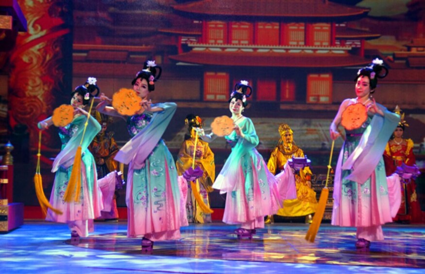 A traditional Chinese dance performance with performers in colorful costumes. 2