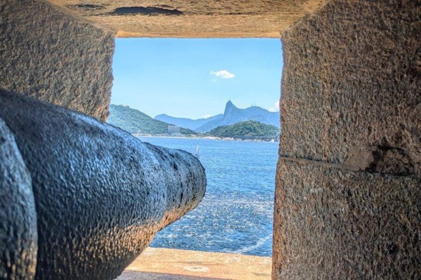 A stone structure with a view of the ocean and mountains. 3