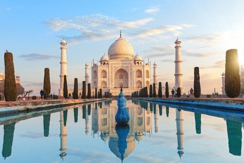 The Taj Mahal with its reflection in the water, four minarets, and a central dome. 1