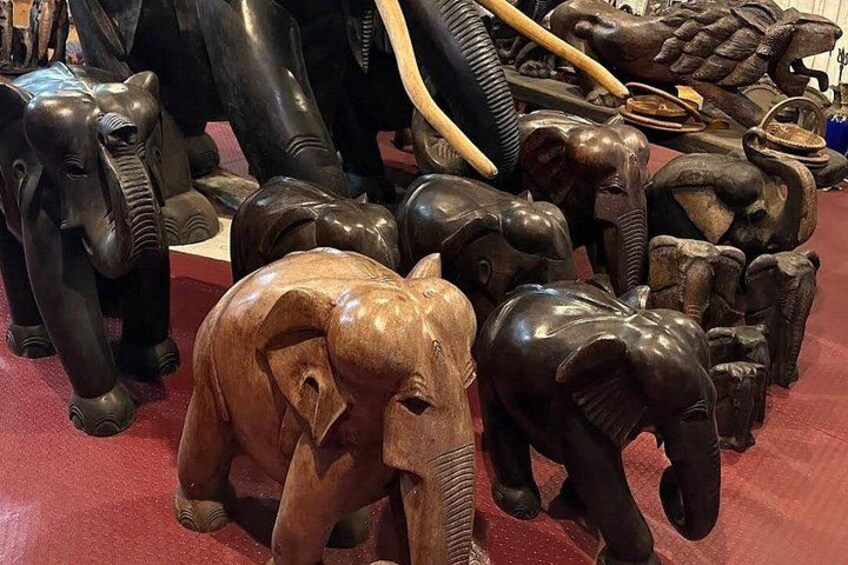 A collection of wooden elephant sculptures. 5