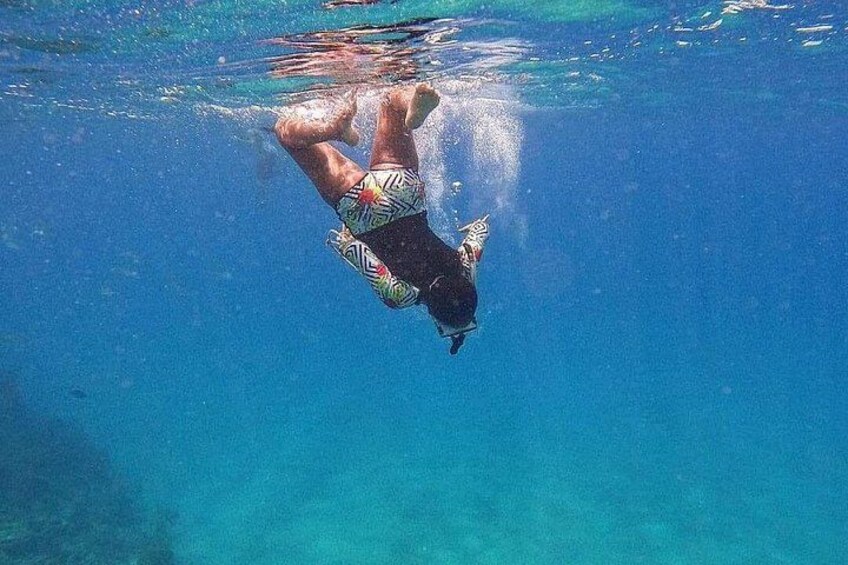 A person swimming underwater. 2