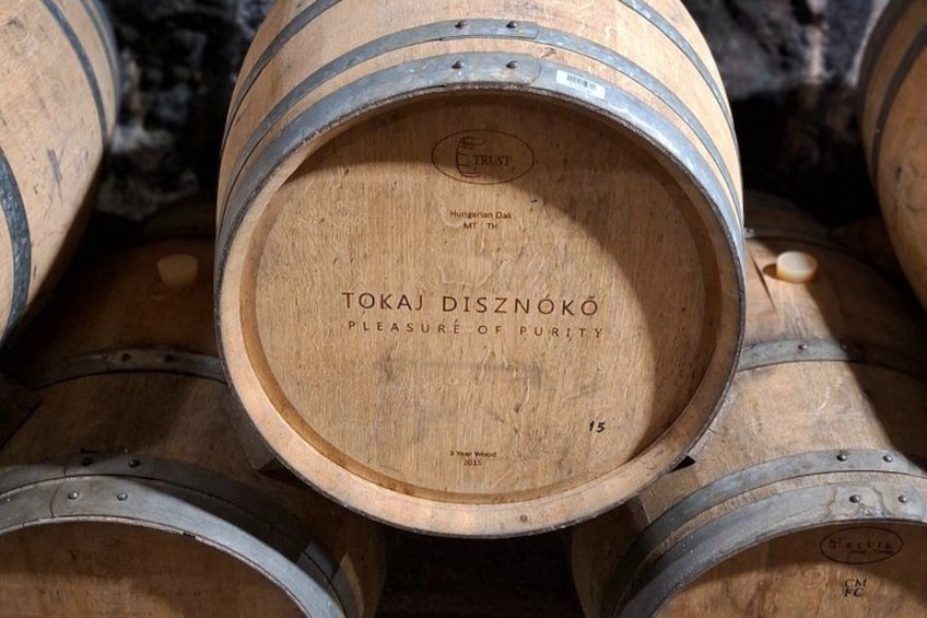 Wooden barrels with 'TOKAJ DISZNOKÓ' and 'PLEASURE OF PURITY' labels. 5