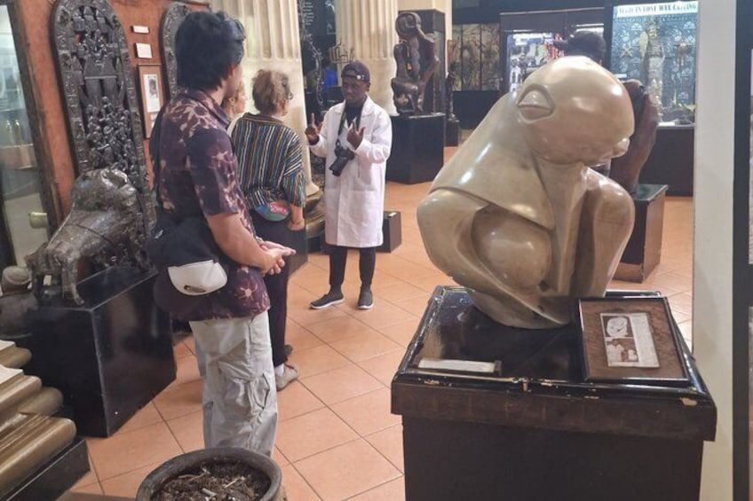 A museum interior with sculptures on display. 4