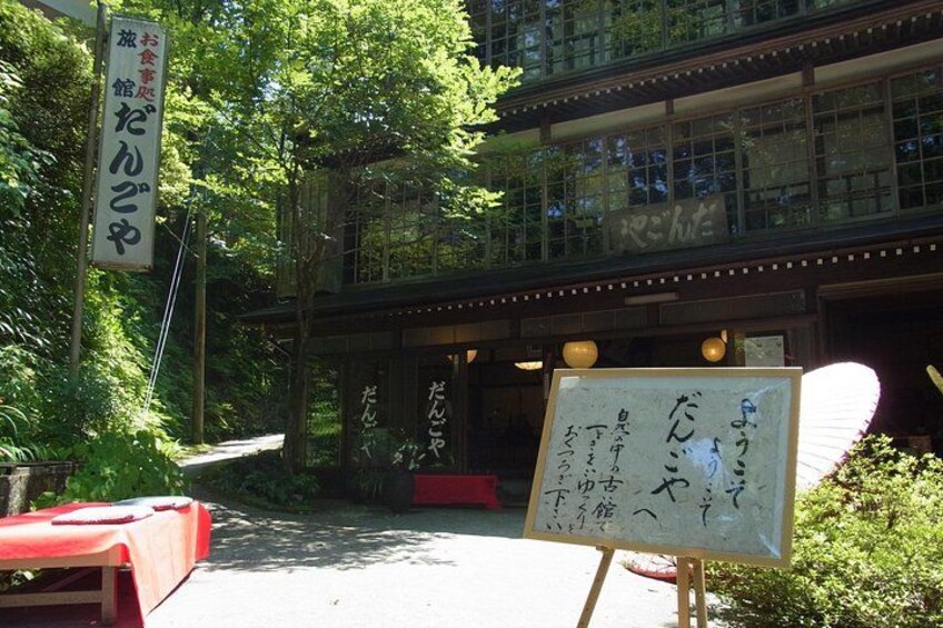 A traditional Japanese building with a red table and a whiteboard with Japanese writing. 4