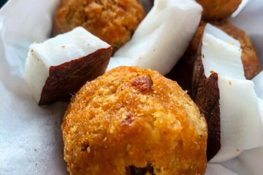 A close-up of a food item, possibly a fried pastry, with a golden-brown crust and a white filling. 4