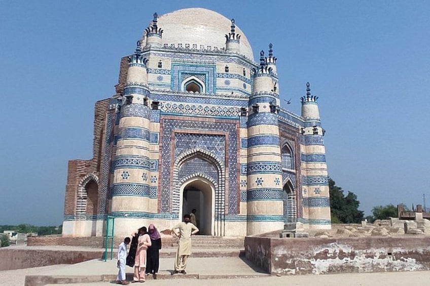 A large, ornate building with a dome and multiple minarets, featuring intricate blue and white tile work. 4