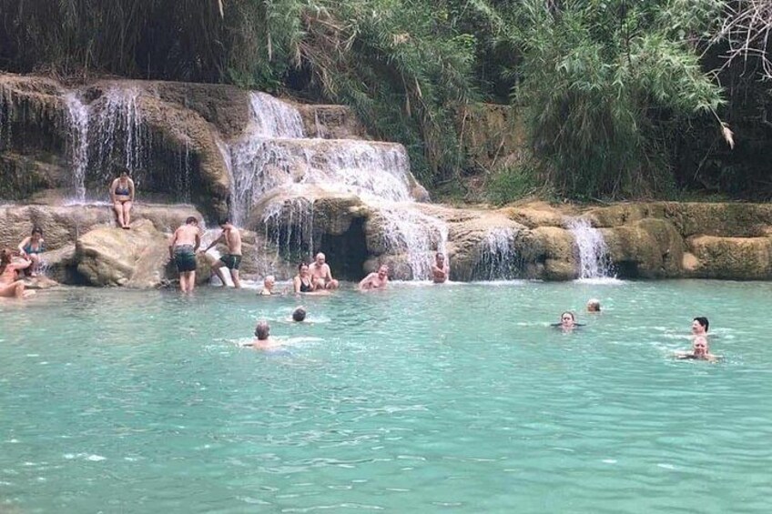 A natural hot spring with people swimming and relaxing. 5