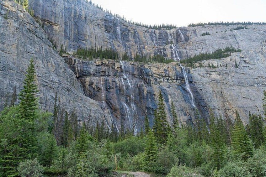 A large rock formation with a waterfall. 2