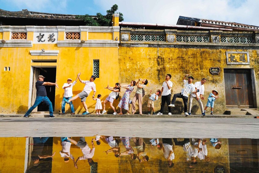 A group of people performing a synchronized dance in front of a yellow building with traditional Chinese architectural elements. 3