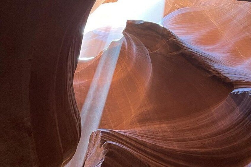 A canyon with smooth, curved sandstone walls and a narrow opening. 2
