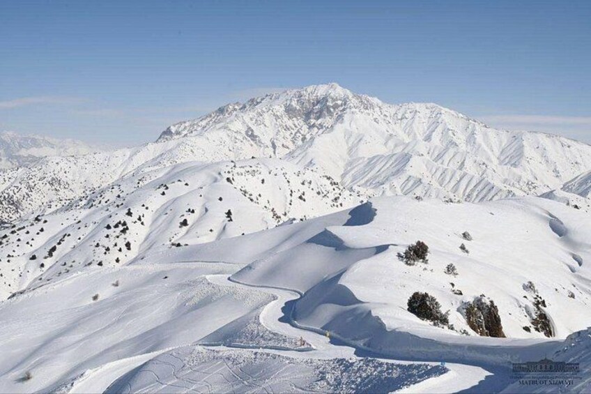 A snow-covered mountain landscape with a clear sky. 3