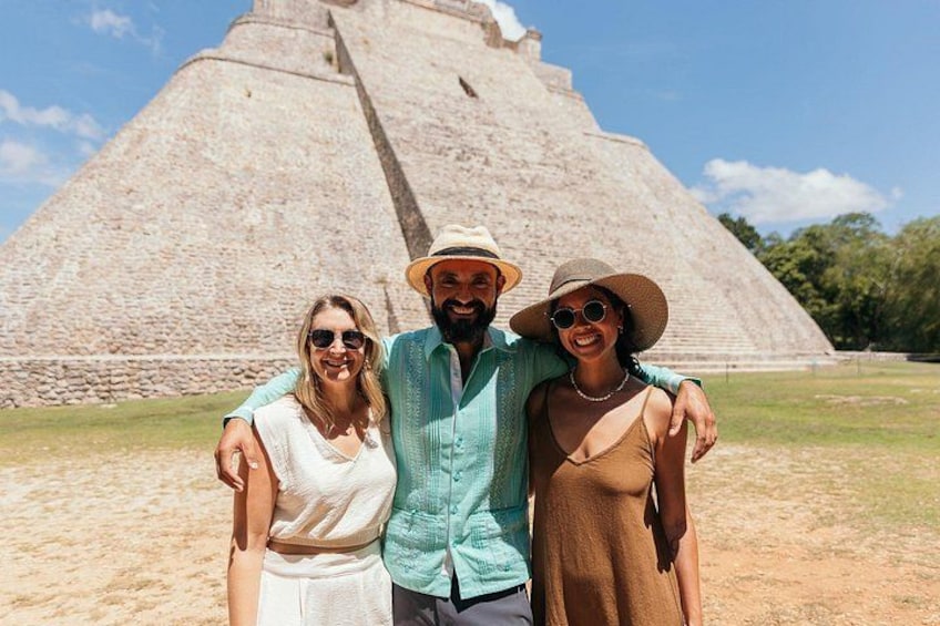 A pyramid structure with three people standing in front of it. 5