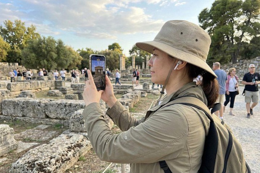 A person taking a photo of ancient ruins with a smartphone. 2