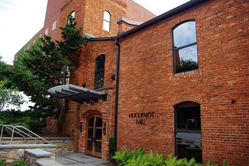 A brick building with a sign that reads 'HUCENOT MILK.' 2