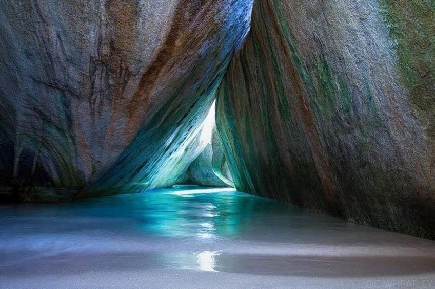 A cave with a water pool and a narrow passage. 1