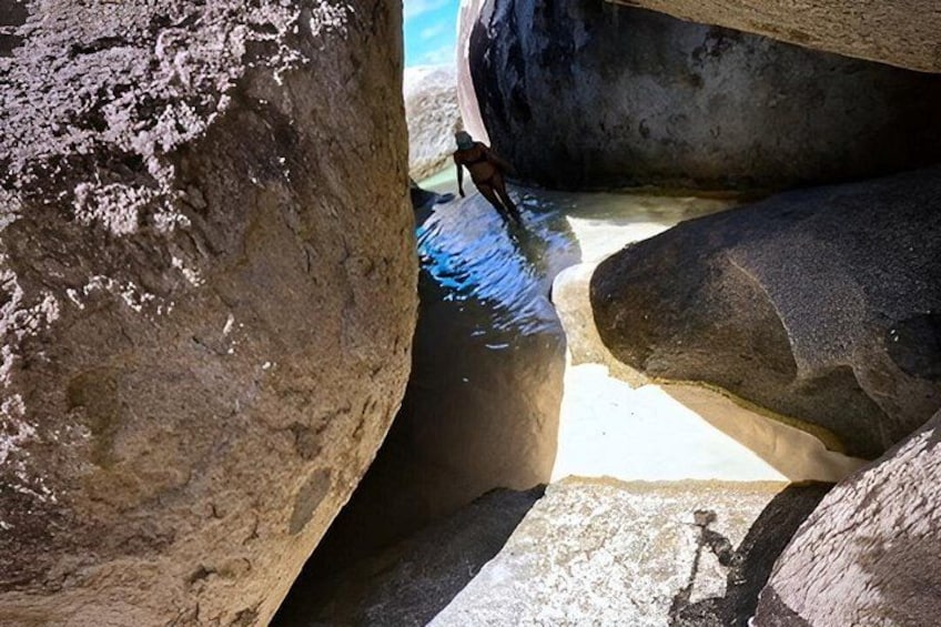 A rocky landscape with large boulders and a small stream. 4