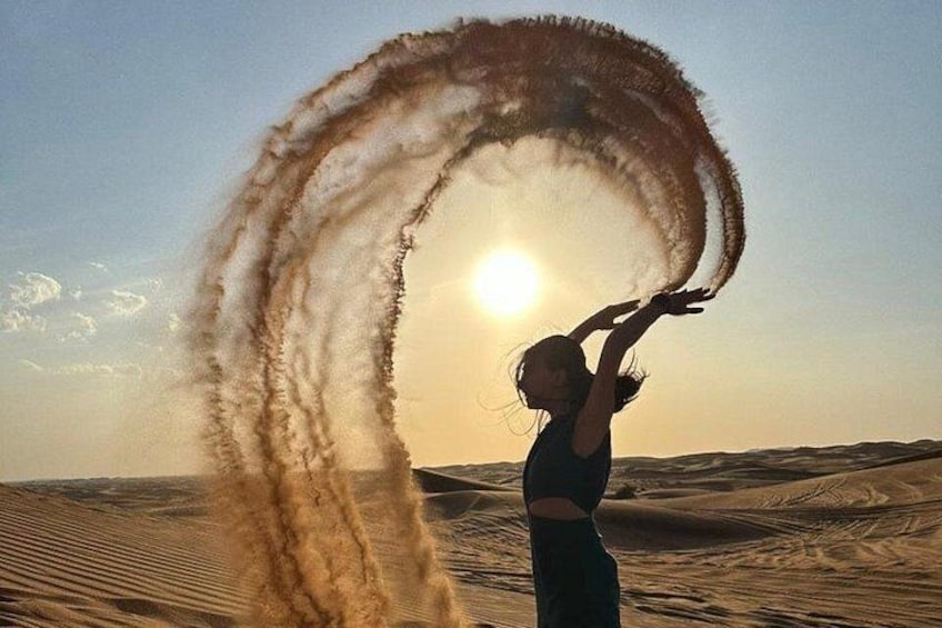 A person in a desert landscape with sand dunes and a clear sky. 2