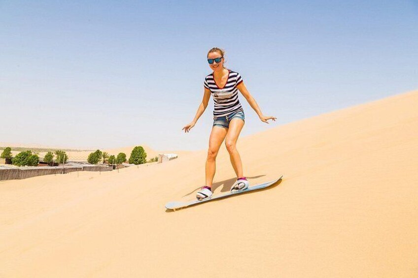 A person snowboarding down a sand dune. 2
