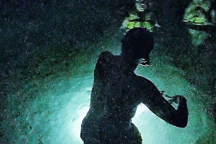 A silhouette of a person in a dark setting with a light source behind them. 4