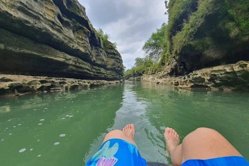 A river with rocky cliffs on either side. 2