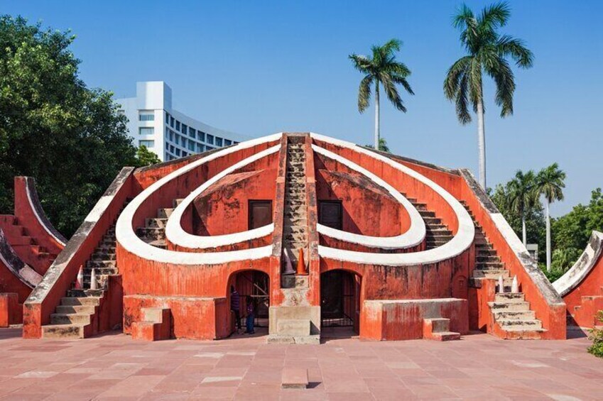 A large, red, spiral staircase structure with a central doorway. 5