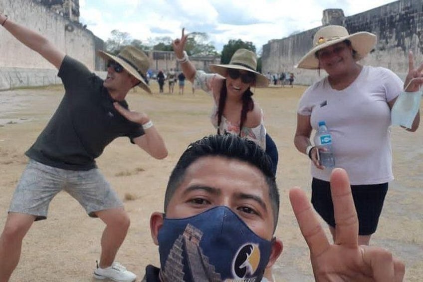A group of people at a historical site with ancient ruins in the background. 3