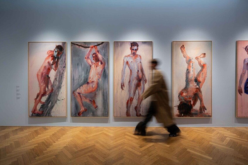 A gallery with abstract paintings on the wall. 4