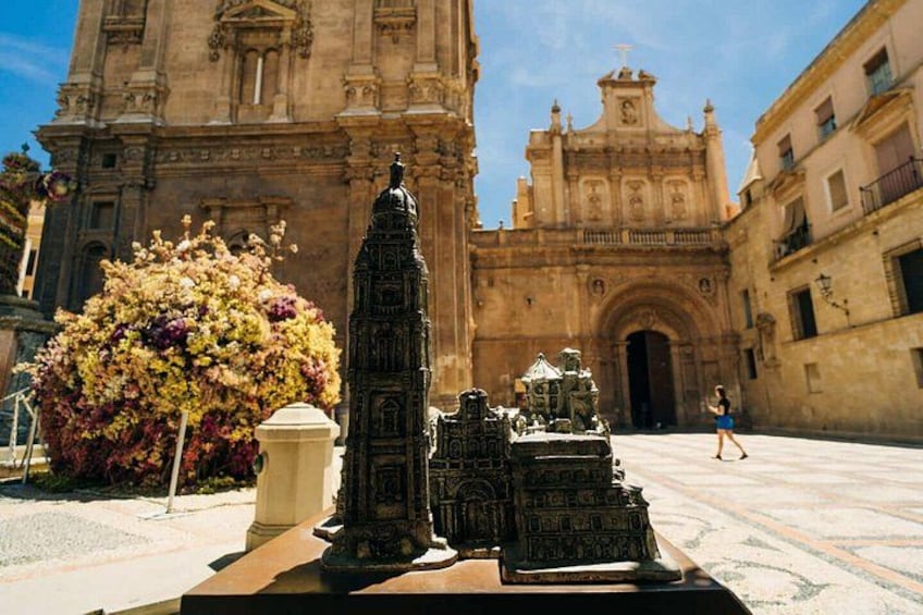 A historical building with intricate architecture, a statue, and a decorative fountain. 5