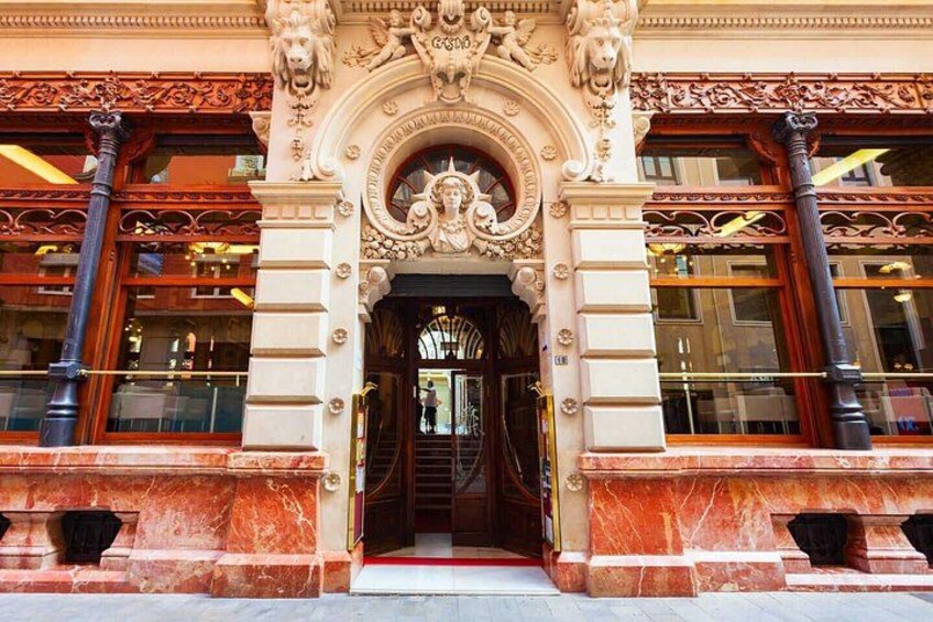 An ornate building entrance with intricate carvings and a grand archway. 4