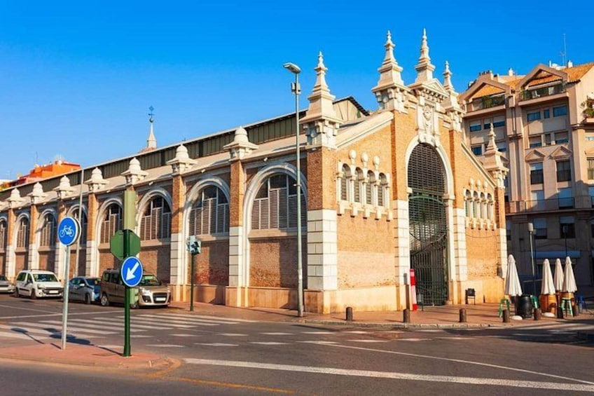 A historic building with arched windows and a large central archway. 3