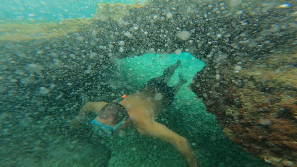 A person snorkeling underwater. 4