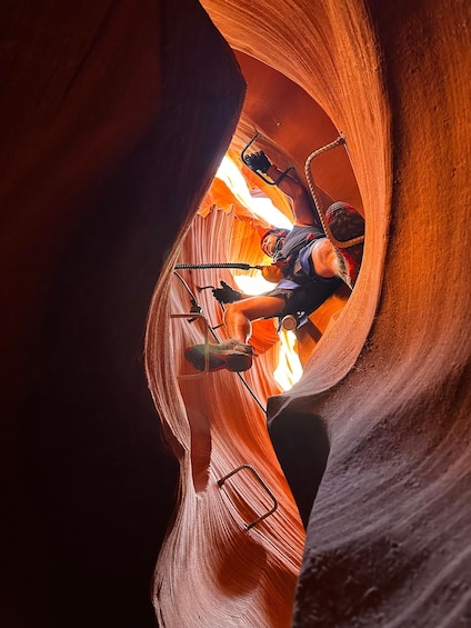 A person rappelling down a narrow canyon with ropes and harnesses. 3