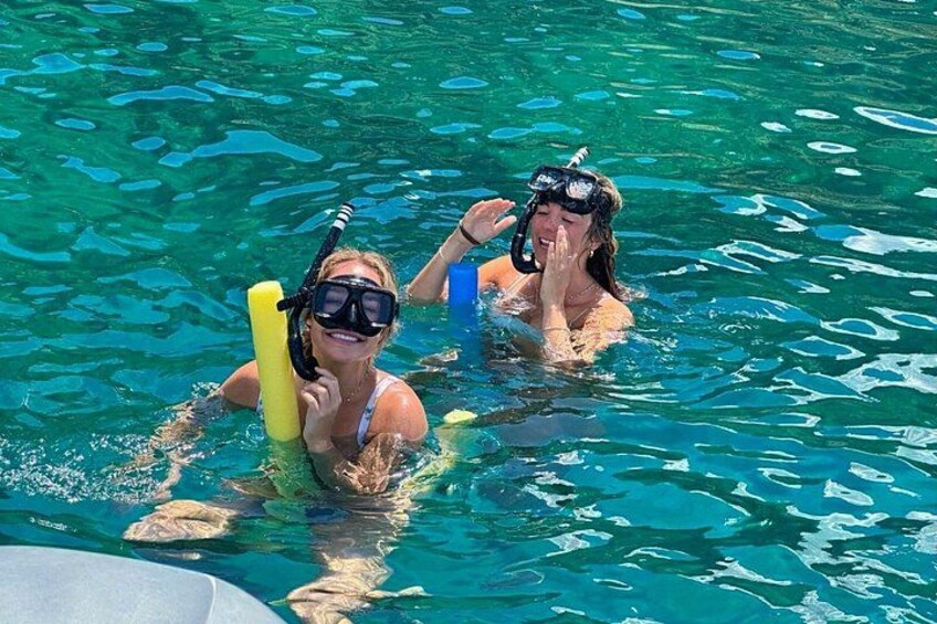 Two people snorkeling in clear blue water. 3
