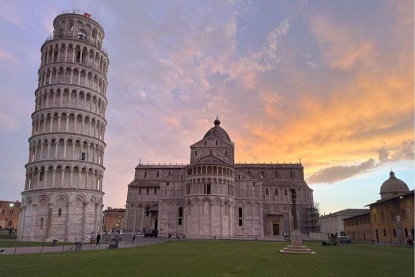 The Leaning Tower of Pisa and the Pisa Cathedral with a sunset sky. 4