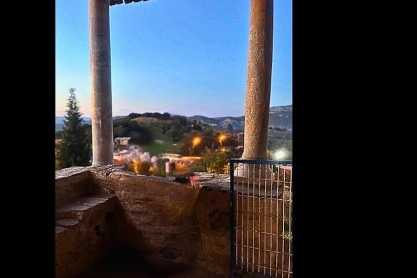 A view of a landscape with a fence and a distant town. 4